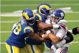  ?? AP Photo/Kyusung Gong, File ?? In this Oct. 4 file photo, Los Angeles Rams linebacker Justin Hollins (58), left, and middle linebacker Micah Kiser (59), center, tackle New York Giants quarterbac­k Daniel Jones (8) during an NFL football game, in Inglewood, Calif. The New York Jets and Giants are both 0-4 for the first time since 1976, and victories might be tough to come by this season. That has left the fans of both teams frustrated, disgusted and already looking to next season just four games into this season.