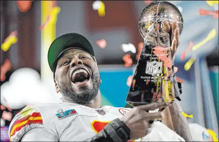  ?? Ashley Landis The Associated Press ?? Kansas City defensive end Carlos Dunlap celebrates with the Vince Lombardi Trophy after the Chiefs won the Super Bowl for the second time in four years.