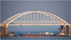  ?? AP ?? A ship under the Kerch bridge that blocks passage to the Kerch Strait, Crimea, on Sunday.