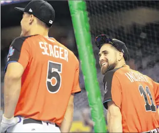  ?? MIKE EHRMANN / GETTY IMAGES ?? Braves outfielder Ender Inciarte, talking with Dodgers shortstop Corey Seager during batting practice for the All-Star Game on Tuesday, is a rising star.