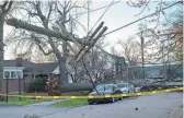  ?? WALKER IV/NASHVILLE TENNESSEAN GEORGE ?? Severe weather and strong winds brought down power poles in Nashville, Tenn., on Friday, some crushing cars. News outlets reported two people died in the state when trees fell on them.