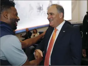  ?? PHOTO/DAVID ZALUBOWSKI ?? Denver Broncos new head coach Vic Fangio (right) greets wide receiver Emmanuel Sanders after a news conference at the team’s headquarte­rs on Thursday, in Englewood, Colo. AP