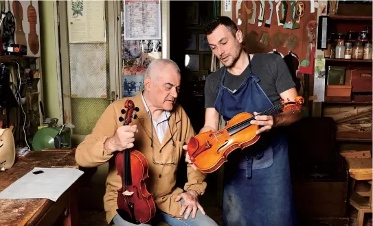  ??  ?? Cremona’s current oldest luthier, Hungary’s Stefano Conia (74) and his son Stefano Jr (47) work at their workshop in Cremona on June 9. Stradivari­us’ homeland, the Italian city of Cremona, has become a laboratory for luthiers from all over the world. — AFP