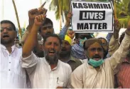  ?? Asif Hassan / AFP via Getty Images ?? Pakistani protesters show their solidarity with people of Indianadmi­nistered Kashmir in Karachi.