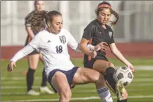  ?? Chris Torres/ The Signal ?? West Ranch freshman Savannah Patton (18) and Castaic sophomore Claire Silvestro (21) battle for the ball in the first half of a Foothill League match.