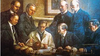  ?? ?? Riddle: A 1915 painting by John Cooke of the Piltdown skull being examined. Charles Dawson and Arthur Smith Woodward are standing back right