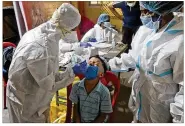  ?? RAFIQMAQBO­OL / AP ?? Health workers collect a sample to test forCOVID-19 in Mumbai, India, Wednesday. India’s total of coronaviru­s infections passed 5 millionWed­nesday.