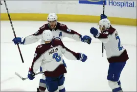  ?? JOHN BAZEMORE — THE ASSOCIATED PRESS ?? Colorado Avalanche right wing Mikko Rantanen (96), center Nathan MacKinnon (29) and defenseman Cale Makar (8) celebrate after the goal by teammate Gabriel Landeskog during the second period of Game 4of the Stanley Cup Finals against the Tampa Bay Lightning on Wednesday, in Tampa, Fla.