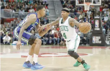  ?? — USA Today Sports ?? Boston Celtics guard Isaiah Thomas (4) drives against Atlanta Hawks forward Kent Bazemore (24) in the third quarter of their game at Philips Arena. The Hawks won 123-116.