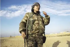  ??  ?? KHUNAYZ: Kimmy Taylor, a 27-year-old British citizen who joined the Kurdish People’s Protection Units (YPG), talks with her comrades near Khunayz on the northern outskirts of Raqa. — AFP