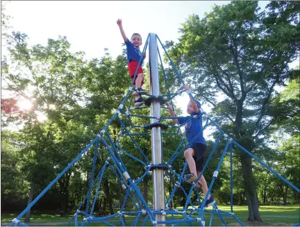  ?? DAN SOKIL — MEDIANEWS GROUP ?? Elian Keddan, left, casts a web while pretending to be Spiderman as his brother Adam climbs to the top of a rope mountain structure at Whites Road Park in Lansdale on Wednesday, June 16.