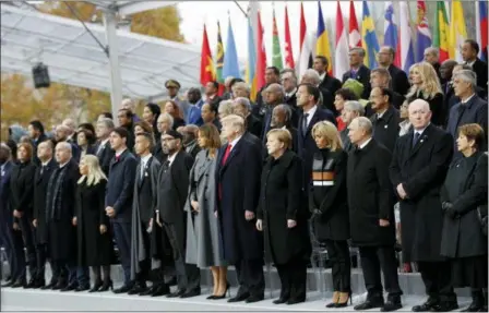  ?? FRANCOIS MORI — THE ASSOCIATED PRESS ?? Heads of states and world leaders attend ceremonies at the Arc de Triomphe Sunday in Paris. Over 60 heads of state and government were taking part in a solemn ceremony at the Tomb of the Unknown Soldier, the mute and powerful symbol of sacrifice to the millions who died from 1914-18.