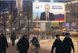  ?? Anatoly Maltsev EPA/Shuttersto­ck ?? A CAMPAIGN advertisem­ent in St. Petersburg for President Vladimir Putin, who is seeking reelection March 18, says “Strong President — Strong Russia.”