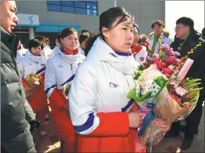  ?? SONG KYUNG-SEOK / AFP ?? Members of the DPRK’s women ice hockey team arrive at the ROK’s national training center in Jincheon on Thursday. Seoul and Pyongyang have agreed to let their athletes march together under a unified flag at an opening ceremony of the upcoming Winter...