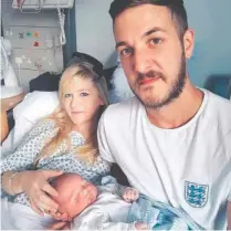  ?? FAMILY OF CHARLIE GARD VIA AP ?? Chris Gard and Connie Yates are shown with their son, Charlie, at Great Ormond Street Hospital in London.