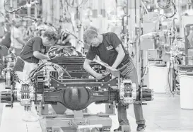  ?? David Richard / Associated Press file ?? Workers assemble a truck at Ford’s plant in Avon Lake, Ohio. The United Auto Workers has reached a tentative contract agreement with Ford.