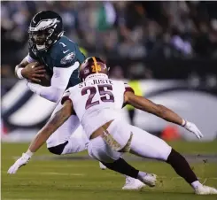  ?? AP PHOTO ?? Philadelph­ia Eagles quarterbac­k Jalen Hurts runs against Washington Commanders cornerback Benjamin St-Juste during the second half of an NFL football game on Monday, Nov. 14, 2022 (November 15 in Manila), in Philadelph­ia.