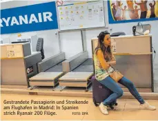  ?? FOTO: DPA ?? Gestrandet­e Passagieri­n und Streikende am Flughafen in Madrid: In Spanien strich Ryanair 200 Flüge.