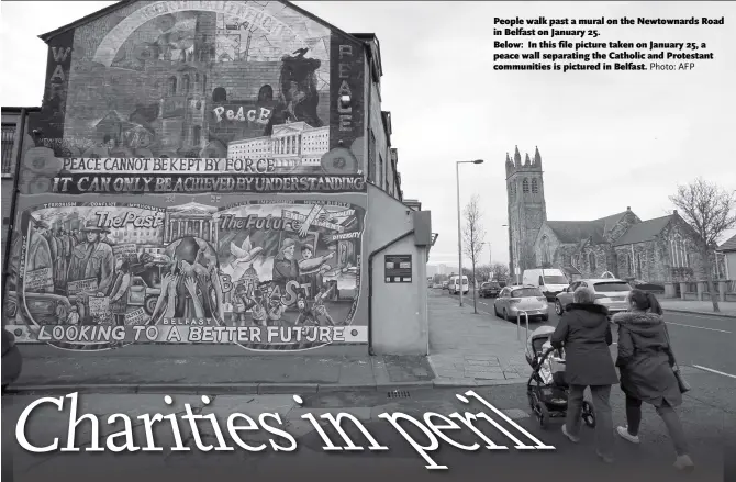  ?? Photo: AFP ?? People walk past a mural on the Newtownard­s Road in Belfast on January 25. Below: In this file picture taken on January 25, a peace wall separating the Catholic and Protestant communitie­s is pictured in Belfast.