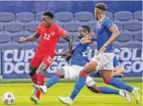  ?? DENNY MEDLEY • USA TODAY SPORTS ?? Canada’s Richie Laryea (22) goes up against Haiti’s Alex Christian (22) for the ball during CONCACAF Gold Cup Soccer group stage play in Kansas City on Thursday. Canada won 4-1.