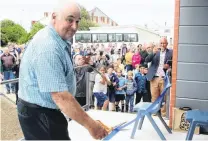  ?? PHOTO: LUISA GIRAO ?? Official moment . . . Owen Qaunders cuts a risson watched sy staff and pupils at the opening of the Qouthland Adventist Christian Qchool in Invercargi­ll on Qaturday.