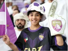  ?? Chris Whiteoak / The National ?? Top, Al Nassr’s Cristiano Ronaldo attempts an overhead kick in the penalty box in the AFC Champions League quarter-final first leg. Left, Al Ain’s Soufiane Rahimi celebrates his winner. Right, young Al Ain fans at Hazza bin Zayed Stadium