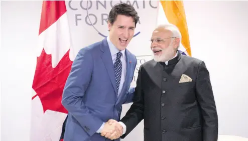  ?? PAUL CHIASSON / THE CANADIAN PRESS ?? Prime Minister Justin Trudeau meets with Indian Prime Minister Narendra Modi in Davos on Tuesday.