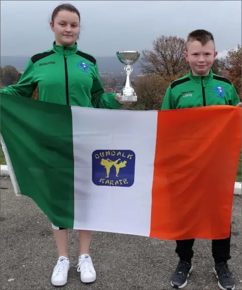  ??  ?? Catherine Marcus with her silver trophy for Kumite with fellow team member Liam Hoey.