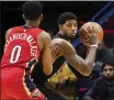  ?? SOPHIA GERMER — THE ASSOCIATED PRESS ?? Paul George, right, made his debut with the Clippers on Thursday, scoring 33 points in a loss to the New Orleans Pelicans.