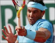 ?? MICHEL EULER — THE ASSOCIATED PRESS ?? Spain’s Rafael Nadal returns the ball to Argentina’s Guido Pella during their second round match of the French Open tennis tournament at the Roland Garros stadium, Thursday in Paris.