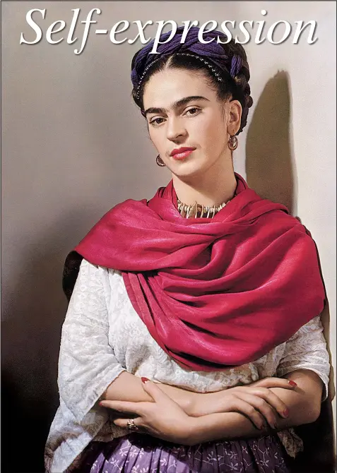  ?? Courtesy Throckmort­on Fine Art, New York ?? Frida Kahlo wears a rebozo (shawl) in Nickolas Muray’s 1939 color carbon print of Kahlo at the Arkansas Arts Center. Frida with Magenta Rebozo“Classic.” It is part of an exhibition of photograph­s