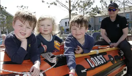  ??  ?? Enjoying Water Safety Awareness Day at Greystones Harbour were Jacob, Beatrice and Nathaniel Kelly aboard the Coastguard Rib with Kenny Liddle.