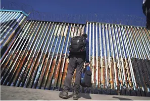  ?? AP Photo/Marco Ugarte, File ?? ■ A migrant waits of the Mexican side of the border after United States Customs and Border Protection officers detained a couple of migrants crossing the U.S.-Mexico border on the beach Jan. 26 in Tijuana, Mexico. About 3 in 10 also worry that more immigratio­n can cause native-born Americans to lose their economic, political and cultural influence, according to a poll by The Associated Press-NORC Center for Public Affairs Research.