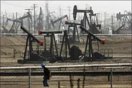  ?? JAE C. HONG, FILE — THE ASSOCIATED PRESS ?? According to the author, creating strict new requiremen­ts on emissions reporting could have a chilling effect on energy production. Here, pumpjacks operating at the Kern River Oil Field in Bakersfiel­d, Calif.