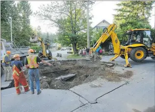  ?? STUART DAVIS/ PNG FILES ?? Municipali­ties have expressed concern about how they could recover the high cost of maintainin­g and installing water systems if they were required to do so. This sinkhole opened up in North Vancouver in July 2010 when a water main blew.