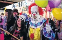  ?? AGUSTIN MARCARIAN/AP FILE PHOTO ?? A man dressed as the “It” clown plays with a girl at Anime Friends — an anime, gaming and comic event in Buenos Aires, Argentina, July 24, 2016.