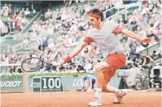  ??  ?? Roger Federer of Switzerlan­d returns a backhand to Ernests Gulbis of Latvia during their men’s singles match at the French Open tennis tournament at the Roland Garros stadium in Paris, in this June 1 file photo. — Reuters photo