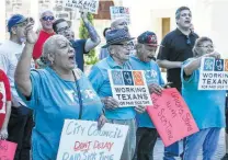  ?? Marvin Pfeiffer / Staff photograph­er ?? Members of Working Texans for Paid Sick Time rally in front of City Hall.