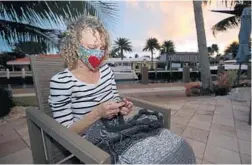  ?? JOHN MCCALL/SOUTH FLORIDA SUN SENTINEL ?? Ruby Cherof knits in the backyard of her Fort Lauderdale home Wednesday. Ruby and her husband have stayed at home since March.