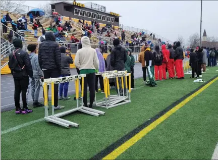  ?? CHRIS LILLSTRUNG — THE NEWS-HERALD ?? Onlookers watch a race from the side of the track during the Ned Weingart Relays at Cleveland Heights in April.