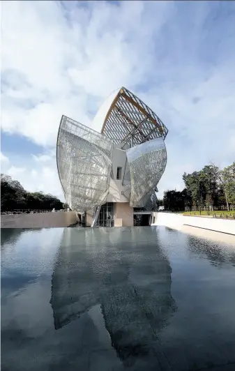  ?? Christophe Ena / Associated Press ?? The $127 million Louis Vuitton Foundation art museum and cultural center created by architect Frank Gehry has been compared to an iceberg or giant sailboat.