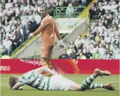  ??  ?? 0 Kristoffer Ajer goes down after clashing with Allan Mcgregor.