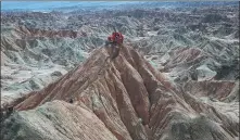  ?? BAO JUNXUAN / FOR CHINA DAILY ?? From left: Surveyors of China National Petroleum Corp’s Tarim Oilfield work in a barren valley in Xinjiang Uygur autonomous region. YU WENGUO / FOR CHINA DAILY An oilfield of the CNPC’s Tarim Oilfield is operating in the Taklimakan.