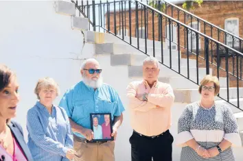  ?? JEFFREY COLLINS/AP ?? The families of two sisters killed in 2010 in Kingstree, S.C., stand by their attorney Lori Murray, far left. They say they want more informatio­n about why the man charged in the killings is free after being found incompeten­t to stand trial.