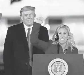  ?? ASSOCIATED PRESS ?? Rep. Marjorie Taylor Greene, R- Ga., and President Donald Trump appear at a campaign rally in support of Senate candidates Kelly Loeffler and David Perdue in Dalton, Ga., on Jan. 4. Both candidates lost to Democrats.