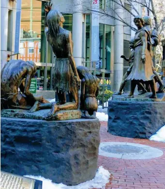  ?? PHOTO COURTESY COLETTE QUINLIN ?? LOOKING BACK: A pair of statues make up the Irish Famine Memorial on Boston’s Irish Heritage Trail.