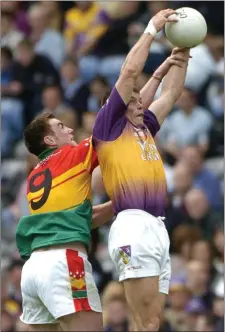  ??  ?? Jim D’Arcy winning this battle in the air with ThomasWals­h of Carlow. His introducti­on to midfield was a key factor in achieving success.