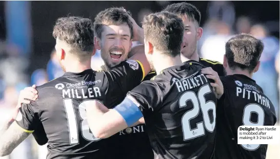  ??  ?? Delight Ryan Hardie is mobbed after making it 3-2 to Livi