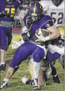  ?? Jenn March / Special to the Times Union ?? Amsterdam defenders take down Ballston Spa running back James Prastio Jr., who ran for 249 yards.