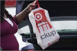  ?? ROGELIO V. SOLIS — THE ASSOCIATED PRESS ?? A Target employee places a curbside pickup purchase into the trunk of a customer in Jackson, Miss.